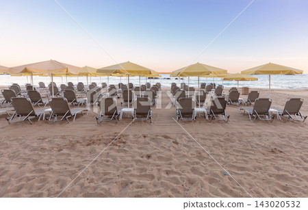 Sun Loungers and Umbrellas on Sandy Beach in Chania, Crete, Greece Sun Loungers and Umbrellas on Sandy Beach in Chania, Crete, Greece 143020532