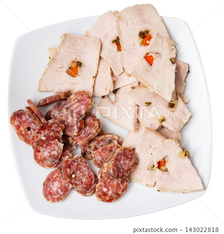 Slices of butifarra and smoked sausage dished up in a service plate on laid restaurant table Slices of butifarra and smoked sausage dished up in a service plate on laid restaurant table 143022818