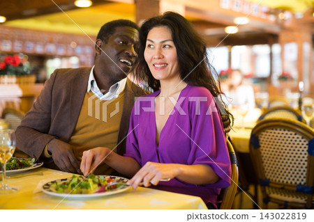 Asian woman and African-american man in restaurant Asian woman and African-american man in restaurant 143022819