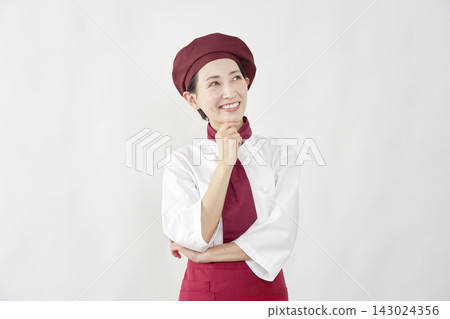 A female pastry chef imagining ideas A female pastry chef imagining ideas 143024356