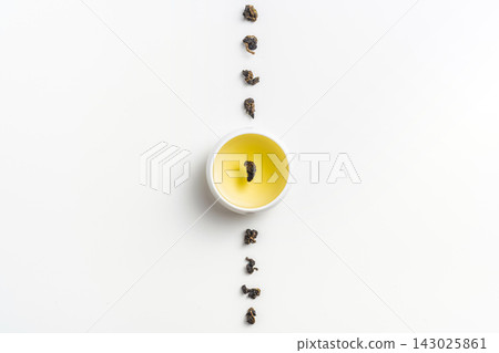 Top view of loose oolong tea leaves and tea cup with leaf isolated on white background with copy space 143025861