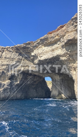 The clear blue Mediterranean Sea and a natural cave opening up in the rocks. The clear blue Mediterranean Sea and a natural cave opening up in the rocks. 143026393