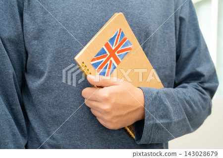 Learn English language, Asian teenage student hold book with flag in course at school. 143028679