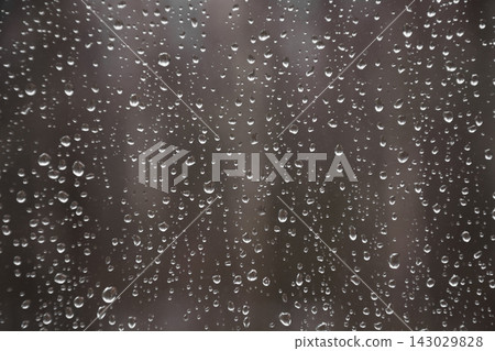 Rain drops on the window on the dark background. Natural pattern.Fall. Rain drops on the window on the dark background. Natural pattern.Fall. 143029828