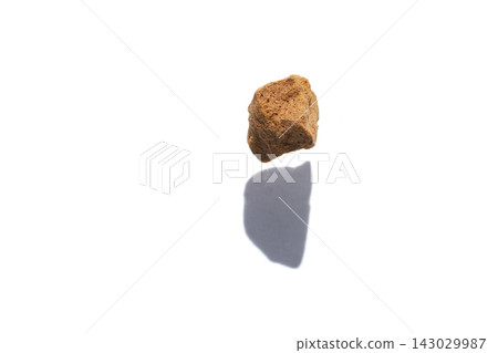 Single Instant Coffee Granule Casting Shadow On White Background Isolated Macro Closeup Single Instant Coffee Granule Casting Shadow On White Background Isolated Macro Closeup 143029987