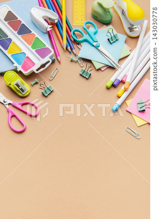 Colorful school and office supplies border on brown background 143030778