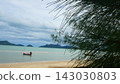 Small Fishing Boats Floating in Calm Sea Near Sandy Beach Under Cloudy Sky 143030803