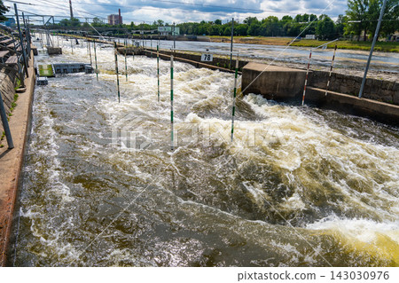 Artificial whitewater slalom course with numbered gates on the Vltava River in Prague Czech Republic. Outdoor kayaking training and canoe slalom concept for water sports and active recreation. Artificial whitewater slalom course with numbered gates on the Vltava River in Prague Czech Republic. Outdoor kayaking training and canoe slalom concept for water sports and active recreation. 143030976