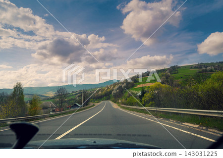 View from windscreen. Driving a car on mountain road View from windscreen. Driving a car on mountain road 143031225
