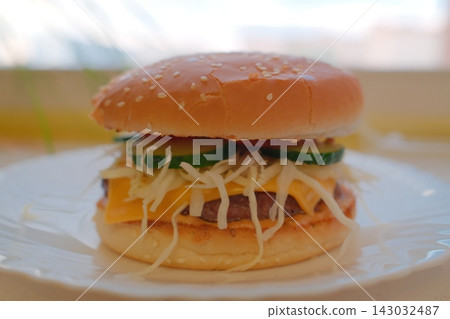 Cheeseburger with cucumber and cabbage slaw Cheeseburger with cucumber and cabbage slaw 143032487