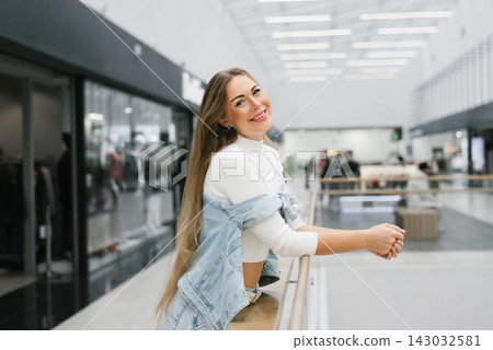 Customer Smiling and Leaning on Railing in Mall Customer Smiling and Leaning on Railing in Mall 143032581