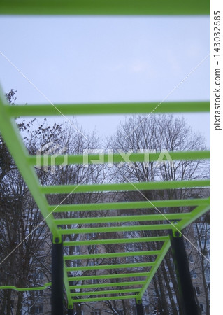 Bright green monkey bars at a city park during a cold winter morning Bright green monkey bars at a city park during a cold winter morning 143032885