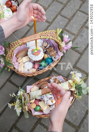 People with candles and Easter food on pavement People with candles and Easter food on pavement 143032958