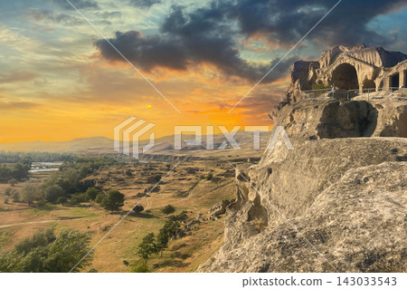 Uplistsikhe ancient rock town and sunset sky cloud near Gori Shida Kartli in Georgia Uplistsikhe ancient rock town and sunset sky cloud near Gori Shida Kartli in Georgia 143033543
