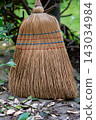 Straw Broom with Dry Leaves on Garden Path 143034984