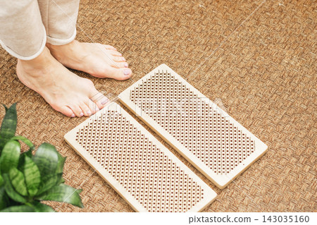 The practice of standing on nails. Woman's legs and board Sadhu. Alternative medicine, of self-knowledge. The practice of standing on nails. Woman's legs and board Sadhu. Alternative medicine, of self-knowledge. 143035160