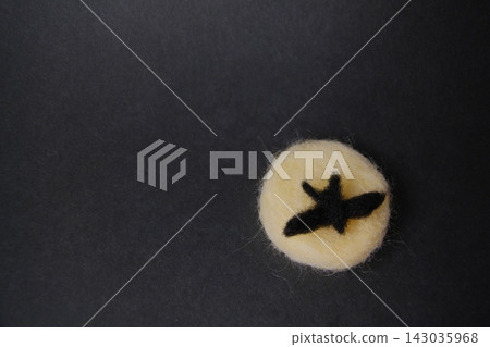 A wool felt bat and a full moon flying in the night sky A wool felt bat and a full moon flying in the night sky 143035968