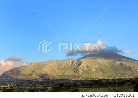 A scenic countryside landscape featuring rolling hills and distant peaks bathed in warm golden light during a peaceful and bright afternoon session A scenic countryside landscape featuring rolling hills and distant peaks bathed in warm golden light during a peaceful and bright afternoon session 143036261