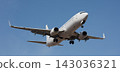 The plane lands. Airplane, passengers flying in the blue sky, preparing to land at the airport 143036321