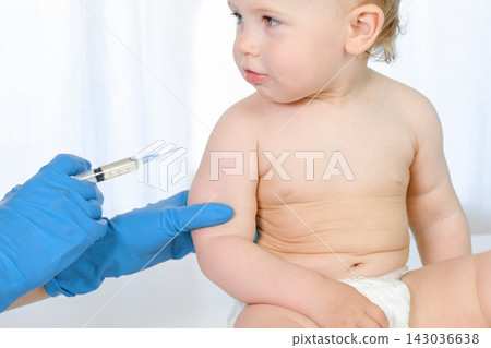 Doctor vaccinating baby in clinic. Little baby get an injection. Pediatrician vaccinating newborn baby. Vaccine for infant child. Child's Immunization, Children's Vaccination, Health concept Doctor vaccinating baby in clinic. Little baby get an injection. Pediatrician vaccinating newborn baby. Vaccine for infant child. Child's Immunization, Children's Vaccination, Health concept 143036638
