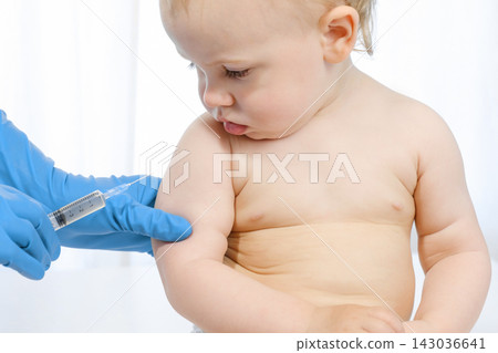 Doctor vaccinating baby in clinic. Little baby get an injection. Pediatrician vaccinating newborn baby. Vaccine for infant child. Child's Immunization, Children's Vaccination, Health concept Doctor vaccinating baby in clinic. Little baby get an injection. Pediatrician vaccinating newborn baby. Vaccine for infant child. Child's Immunization, Children's Vaccination, Health concept 143036641