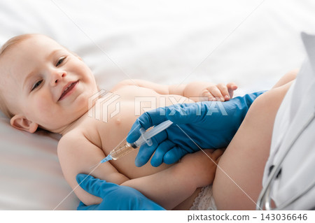 Doctor vaccinating baby in clinic. Little baby get an injection. Pediatrician vaccinating newborn baby. Vaccine for infant child. Child's Immunization, Children's Vaccination, Health concept Doctor vaccinating baby in clinic. Little baby get an injection. Pediatrician vaccinating newborn baby. Vaccine for infant child. Child's Immunization, Children's Vaccination, Health concept 143036646