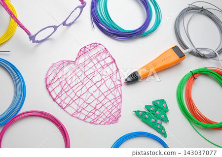 3d Pen. Printing with Colored Plastic Wire Filament. Child making a Christmas Three, Heart shape drawing with 3D pen. Artwork, Robotics. STEAM, STEM education. Modern Technologies. Study at home 3d Pen. Printing with Colored Plastic Wire Filament. Child making a Christmas Three, Heart shape drawing with 3D pen. Artwork, Robotics. STEAM, STEM education. Modern Technologies. Study at home 143037077