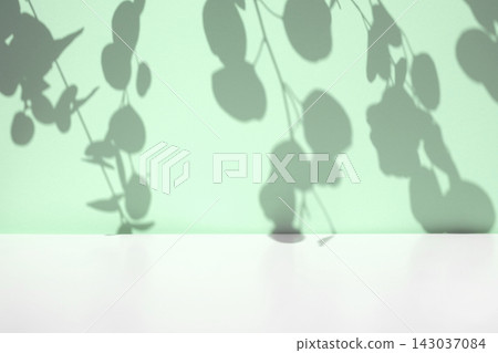 Plant shadows on neutral color wall. Leaves shadow background. Branches, flowers and foliage on pastel studio background. Product presentation, Minimal mock up for advertising. Trendy Overlay effect Plant shadows on neutral color wall. Leaves shadow background. Branches, flowers and foliage on pastel studio background. Product presentation, Minimal mock up for advertising. Trendy Overlay effect 143037084
