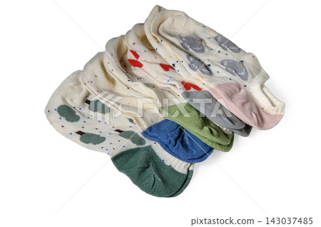 Neat stack of folded white ankle socks with diverse patterns and colorful heels Neat stack of folded white ankle socks with diverse patterns and colorful heels 143037485