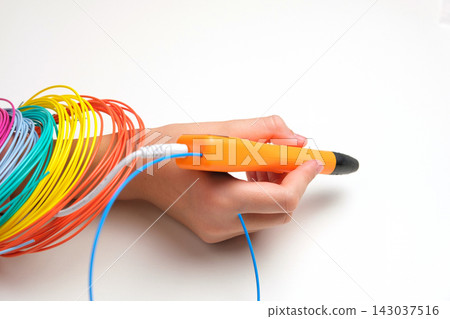 Teen Girl Using 3d Pen. Printing with Colored Plastic Wire Filament. Child making a House, drawing with 3D pen. Artwork, Robotics. STEAM, STEM education. Modern Technologies. Play and study at home Teen Girl Using 3d Pen. Printing with Colored Plastic Wire Filament. Child making a House, drawing with 3D pen. Artwork, Robotics. STEAM, STEM education. Modern Technologies. Play and study at home 143037516