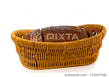 Commercial stock photo of a sliced artisan rye loaf neatly arranged within a wicker bread basket Commercial stock photo of a sliced artisan rye loaf neatly arranged within a wicker bread basket 143037580