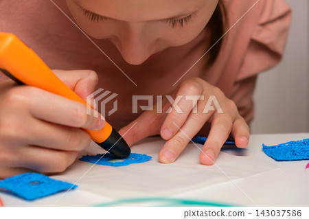 Teen Girl Using 3d Pen. Printing with Colored Plastic Wire Filament. Child making a House, drawing with 3D pen. Artwork, Robotics. STEAM, STEM education. Modern Technologies. Play and study at home Teen Girl Using 3d Pen. Printing with Colored Plastic Wire Filament. Child making a House, drawing with 3D pen. Artwork, Robotics. STEAM, STEM education. Modern Technologies. Play and study at home 143037586