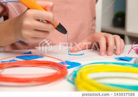 Teen Girl Using 3d Pen. Printing with Colored Plastic Wire Filament. Child making a House, drawing with 3D pen. Artwork, Robotics. STEAM, STEM education. Modern Technologies. Play and study at home 143037588