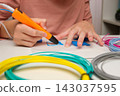 Teen Girl Using 3d Pen. Printing with Colored Plastic Wire Filament. Child making a House, drawing with 3D pen. Artwork, Robotics. STEAM, STEM education. Modern Technologies. Play and study at home 143037595