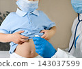 Medical examining boy in clinic. Little child checked by doctor. Pediatrician with stethoscope with face mask and toddler in a hospital. Check heart lungs of kid. Pediatric checkup in hospital 143037599