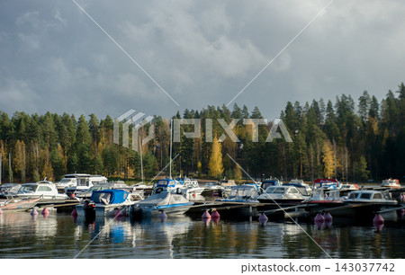 Busy Marina Harbor with Boats and Yachts Docked in Autumn Busy Marina Harbor with Boats and Yachts Docked in Autumn 143037742
