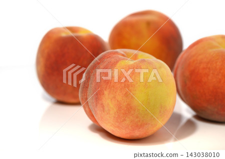 Commercial stock photo of fresh whole ripe peaches arranged on a white background Commercial stock photo of fresh whole ripe peaches arranged on a white background 143038010