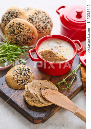 Gourmet Liver Pate Appetizer with Sesame Seed Bagels and and Fresh Pea Shoots on Rustic Wooden Board Gourmet Liver Pate Appetizer with Sesame Seed Bagels and and Fresh Pea Shoots on Rustic Wooden Board 143038441