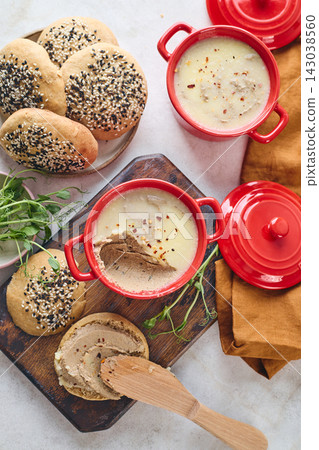 Gourmet Liver Pate Appetizer with Sesame Seed Bagels and and Fresh Pea Shoots on Rustic Wooden Board Gourmet Liver Pate Appetizer with Sesame Seed Bagels and and Fresh Pea Shoots on Rustic Wooden Board 143038560