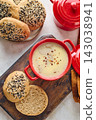 Gourmet Liver Pate Appetizer with Sesame Seed Bagels and and Fresh Pea Shoots on Rustic Wooden Board 143038941
