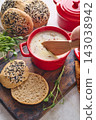 Gourmet Liver Pate Appetizer with Sesame Seed Bagels and and Fresh Pea Shoots on Rustic Wooden Board 143038942