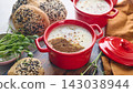 Gourmet Liver Pate Appetizer with Sesame Seed Bagels and and Fresh Pea Shoots on Rustic Wooden Board 143038944