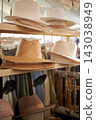 Stylish hats made of felt, fabric and straw are displayed at street market. 143038949