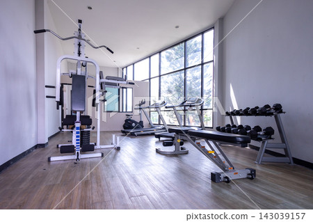 Spacious and Bright Modern Fitness Center Interior with Equipment Spacious and Bright Modern Fitness Center Interior with Equipment 143039157