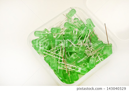 Green LEDs in a plastic box. Semiconductor diodes. Electronic components. Green LEDs in a plastic box. Semiconductor diodes. Electronic components. 143040329