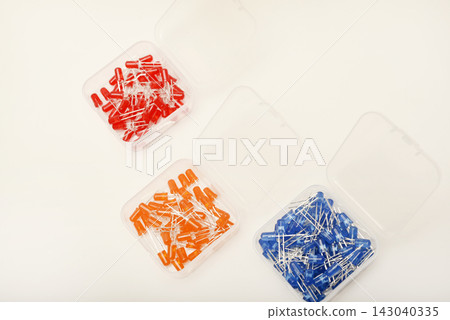 Multicolored LEDs in a plastic box. Semiconductor diodes. Electronic components. Multicolored LEDs in a plastic box. Semiconductor diodes. Electronic components. 143040335