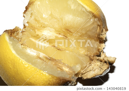 A mouldy lemon decaying on white background A mouldy lemon decaying on white background 143040819