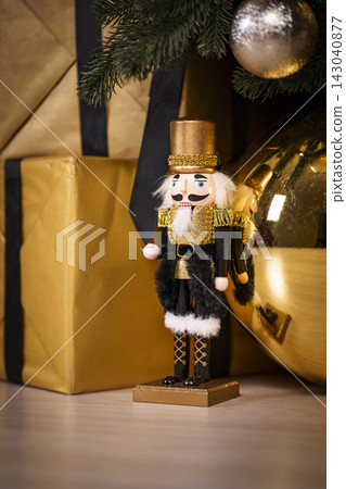 Vintage Nutcracker Soldier Standing by Golden Christmas Gifts Vintage Nutcracker Soldier Standing by Golden Christmas Gifts 143040877