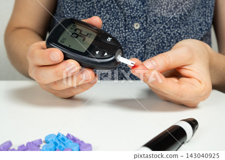 Measuring blood glucose levels, sugar test with a home glucometer Measuring blood glucose levels, sugar test with a home glucometer 143040925