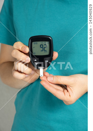 Measuring blood glucose levels, sugar test with a home glucometer 143040929